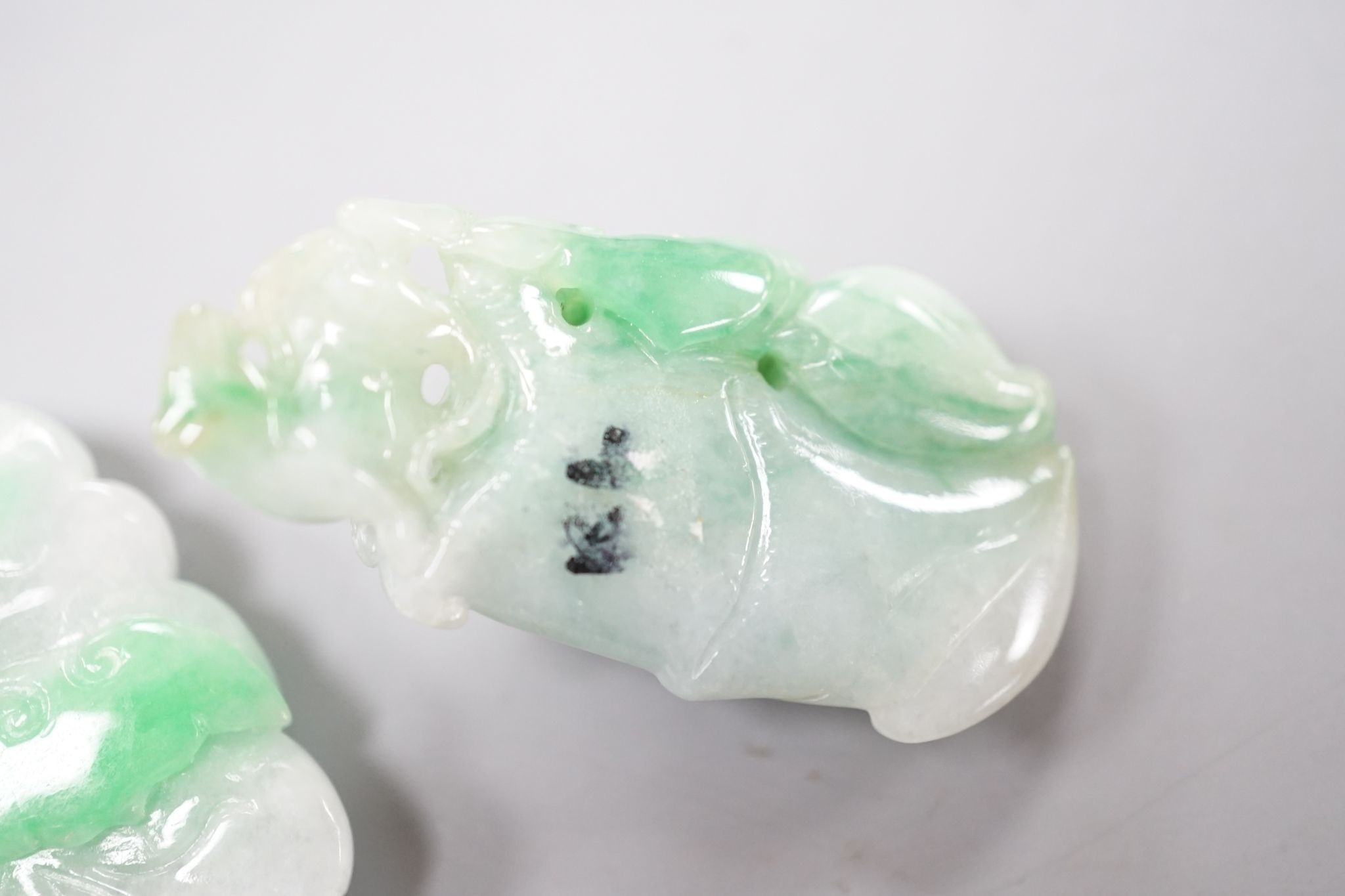 Two carved jade pendants, largest 45mm.